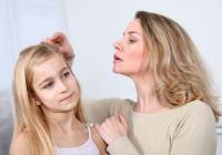 Mother InspectingChild&#039;s Scalp and Hair for Lice